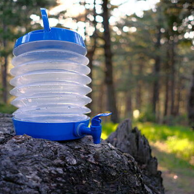 Plastic canister with blue tap in the forest